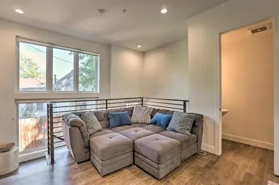 a living room with a couch and a window at Golden Rooftop w Mountain Views - Walk to DT Golden School of Mines Close to Red Rocks in Golden