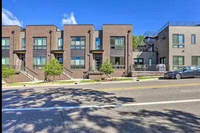 a car parked in front of a large brick building at Golden Rooftop w Mountain Views - Walk to DT Golden School of Mines Close to Red Rocks in Golden