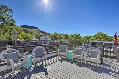 a row of chairs sitting on a wooden deck at Golden Rooftop w Mountain Views - Walk to DT Golden School of Mines Close to Red Rocks in Golden
