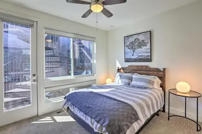 a bedroom with a bed and a large window at Golden Rooftop w Mountain Views - Walk to DT Golden School of Mines Close to Red Rocks in Golden