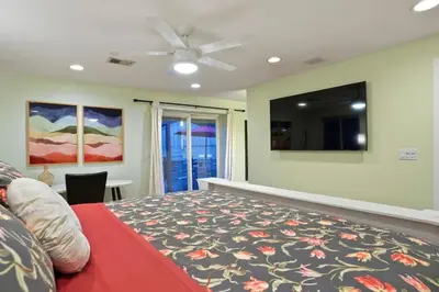 a bedroom with a bed and a ceiling fan at Shakedown St HOT TUB Fire Pit and 4 Miles to DT in Denver