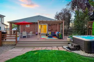 a backyard deck with a pool and a house at Shakedown St HOT TUB Fire Pit and 4 Miles to DT in Denver