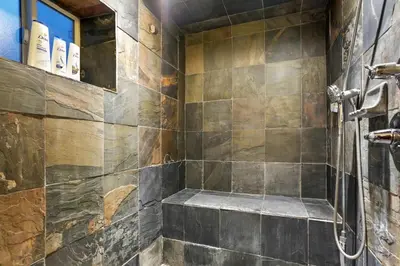 a bathroom with a walk in shower next to a glass shower at Shakedown St HOT TUB Fire Pit and 4 Miles to DT in Denver