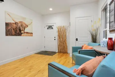 a living room with a blue couch and a table at Shakedown St HOT TUB Fire Pit and 4 Miles to DT in Denver