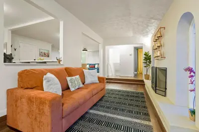 a living room with a couch and a tv at Unforgettable Stay HOT TUB and Fire Pit and 4 Miles to DT Denver in Denver