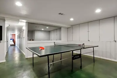 a ping pong table in the middle of a room at Unforgettable Stay HOT TUB and Fire Pit and 4 Miles to DT Denver in Denver
