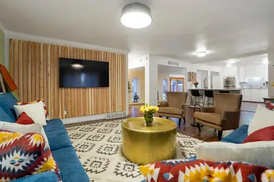 a living room with a couch and a table at Unforgettable Stay HOT TUB and Fire Pit and 4 Miles to DT Denver in Denver