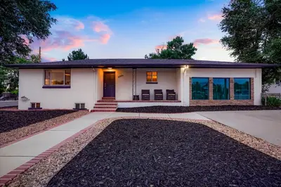 a small white house with a driveway at Unforgettable Stay HOT TUB and Fire Pit and 4 Miles to DT Denver in Denver