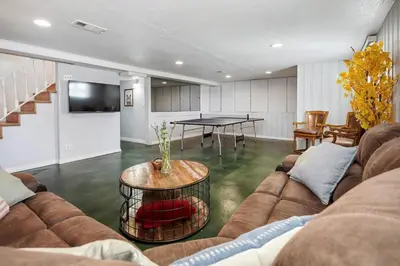 a living room with a couch and a table at Unforgettable Stay HOT TUB and Fire Pit and 4 Miles to DT Denver in Denver