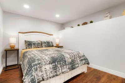 a bedroom with a bed and two night stands at One of a Kind Home with HOT TUB Pool Table and Fire Pit 4 Miles to DT in Denver