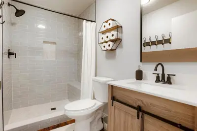 a bathroom with a toilet and a sink and a shower at One of a Kind Home with HOT TUB Pool Table and Fire Pit 4 Miles to DT in Denver