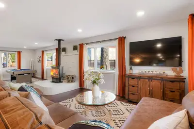 a living room with a couch and a table at One of a Kind Home with HOT TUB Pool Table and Fire Pit 4 Miles to DT in Denver