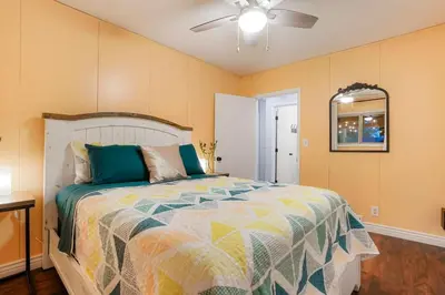 a bedroom with a bed and a ceiling fan at One of a Kind Home with HOT TUB Pool Table and Fire Pit 4 Miles to DT in Denver