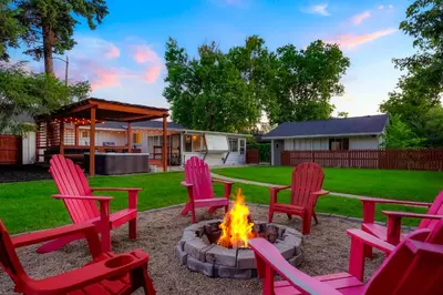 a fire pit in a yard with red chairs at Best Experience in Denver HOT TUB and FIRE PIT 4 miles to DT in Denver