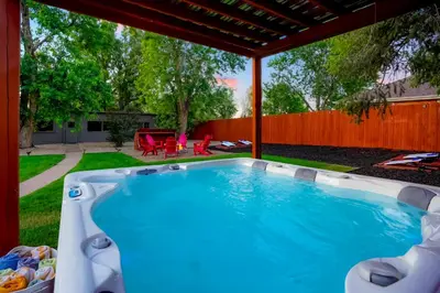 a swimming pool in a backyard with a pergola at Best Experience in Denver HOT TUB and FIRE PIT 4 miles to DT in Denver