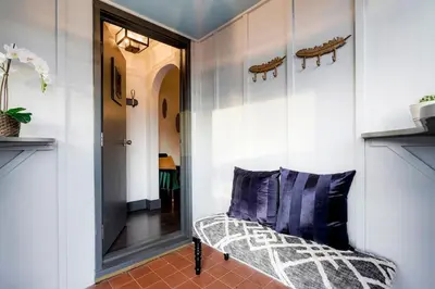 a hallway with a bench and a mirror at Best Experience in Denver HOT TUB and FIRE PIT 4 miles to DT in Denver