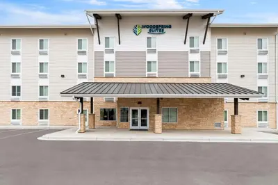 a hotel with a parking lot in front of it at WoodSpring Suites Denver Commerce City in Commerce City