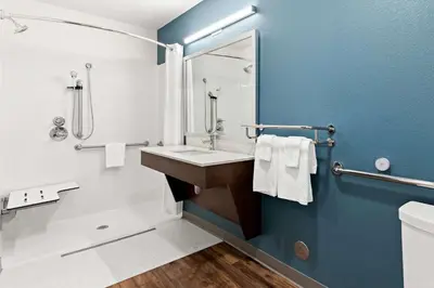 a bathroom with a sink and a tub and a shower at WoodSpring Suites Denver Commerce City in Commerce City