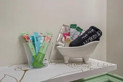 a bathroom counter with a toothbrush and toothpaste in a sink at Club Hotel in Idaho Springs