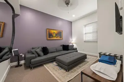 a living room with a gray couch and a table at Club Hotel in Idaho Springs