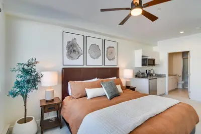 a bedroom with a large bed and a ceiling fan at 2 Mi to Fraser Tubing Hill Condo with Fireplace! in Fraser