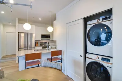 a kitchen and living room with a washer and dryer at 2 Mi to Fraser Tubing Hill Condo with Fireplace! in Fraser