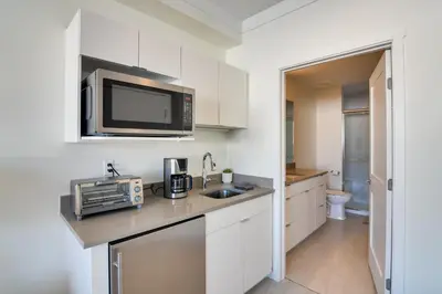 a kitchen with a counter top with a microwave at 2 Mi to Fraser Tubing Hill Condo with Fireplace! in Fraser