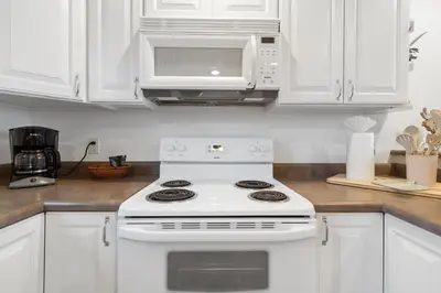 a kitchen with a white stove and a microwave at The Loose Moose Lodge in Grand Lake
