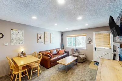 a living room with a couch and a table at Hi Country Haus Haven in Winter Park