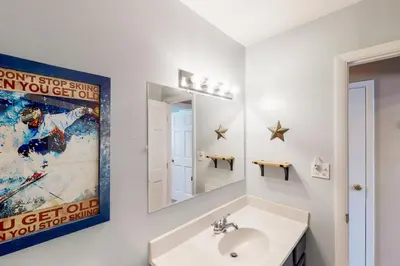 a bathroom with a sink and a mirror at Hi Country Haus Haven in Winter Park