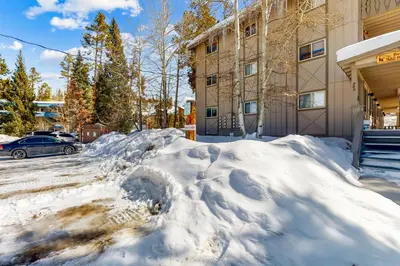 a pile of snow in front of a building at Hi Country Haus Haven in Winter Park