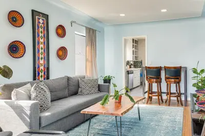 a living room with a couch and a table at 7 Mi to Denver Inviting Aurora Home with Yard! in Aurora