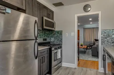 a kitchen with a stainless steel refrigerator and a stove at 7 Mi to Denver Inviting Aurora Home with Yard! in Aurora