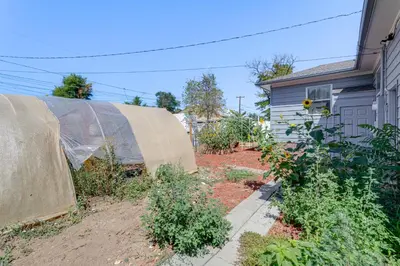 a garden with a fence and some plants at 7 Mi to Denver Inviting Aurora Home with Yard! in Aurora