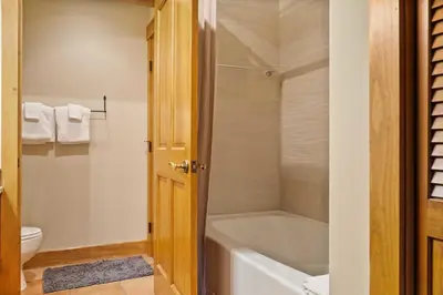 a bathroom with a bath tub and a toilet at River Run 2BD Condo Walk to Ski and Lift in Keystone
