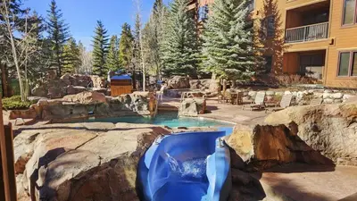 a water slide in a pool in a yard at River Run 2BD Condo Walk to Ski and Lift in Keystone