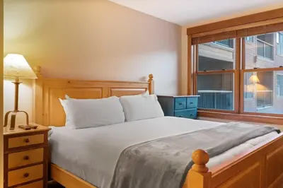 a bedroom with a large bed and a window at River Run 2BD Condo Walk to Ski and Lift in Keystone