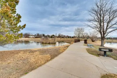 a park with two benches next to a river at 10 Mi to Denver Pet-Friendly Arvada Home with Yard! in Arvada