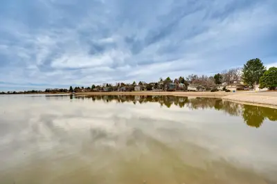 a large body of water with houses in the background at 10 Mi to Denver Pet-Friendly Arvada Home with Yard! in Arvada
