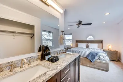 a bedroom with a bed and a tub and a sink at 10 Mi to Denver Pet-Friendly Arvada Home with Yard! in Arvada