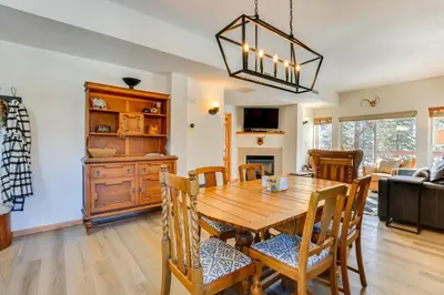 a dining room with a wooden table and chairs at Fantastic Fraser Condo Year-Round Family Getaway in Fraser
