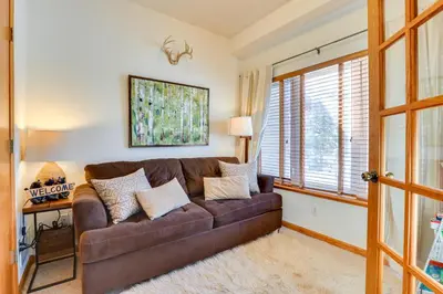 a living room with a brown couch and a window at Fantastic Fraser Condo Year-Round Family Getaway in Fraser