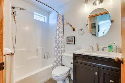 a bathroom with a sink and a toilet and a bathtub at Fantastic Fraser Condo Year-Round Family Getaway in Fraser