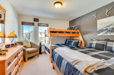 a bedroom with a bunk bed and a chair at Fantastic Fraser Condo Year-Round Family Getaway in Fraser