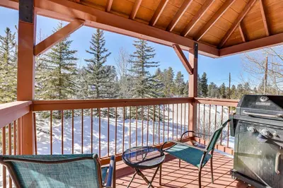 a screened in porch with two chairs and a grill at Fantastic Fraser Condo Year-Round Family Getaway in Fraser