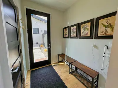 a hallway with a wooden bench and a window at Modern Luxury Home I Sleeps 8 I 10min to Downtown in Denver
