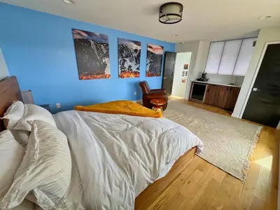 a bedroom with a white bed and a blue wall at Modern Luxury Home I Sleeps 8 I 10min to Downtown in Denver