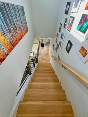 a staircase in a house with art on the walls at Modern Luxury Home I Sleeps 8 I 10min to Downtown in Denver