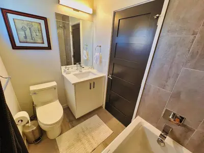 a bathroom with a toilet and a sink and a shower at Modern Luxury Home I Sleeps 8 I 10min to Downtown in Denver