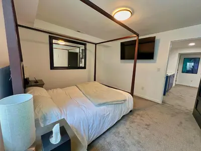 a bedroom with a bed and a mirror in it at Modern Luxury Home I Sleeps 8 I 10min to Downtown in Denver